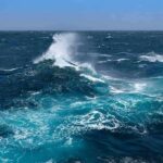 Trump Approves Emergency Aid for Florida Ocean waves crashing with white spray under a clear blue sky