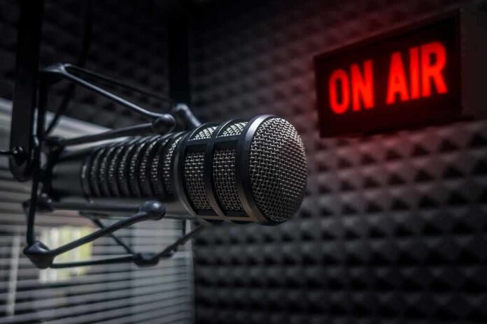Close-up of a studio microphone with an illuminated on-air sign