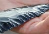 Ancient Tar Shows Promise, but Scientists Warn Against Big Claims Hand holding a flaked obsidian blade