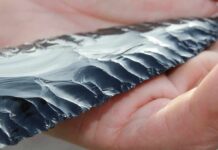 Ancient Tar Shows Promise, but Scientists Warn Against Big Claims Hand holding a flaked obsidian blade