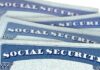 $140K Debt Linked to Stolen Social Security Numbers Social Security cards stacked in a close-up view
