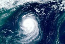 Trump Cancels Game Visit Over Hurricane Satellite view of a powerful hurricane swirling over the ocean