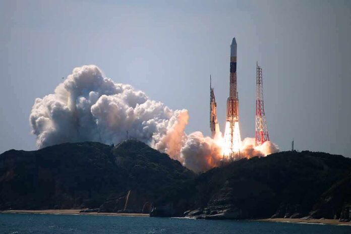 shutterstock_1626273565 Rocket lifts off from coastal launch site with smoke and flames