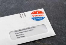 Brutal Poll: Trump Approval Hits New Low Absentee ballot envelope with I Voted sticker on dark surface