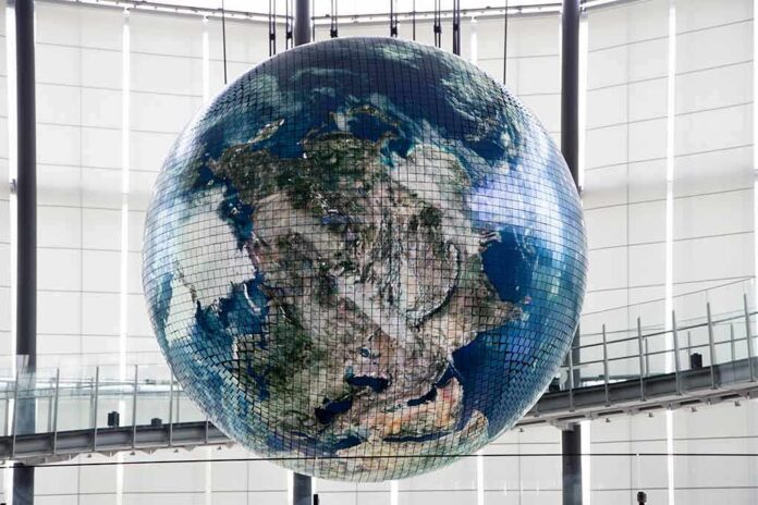 shutterstock_1758097349 Hanging digital Earth globe in modern atrium