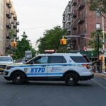 ICE Gunfire Erupts: Bronx Residents Demand Answers NYPD police SUV blocking a city street at a taped-off scene
