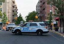 ICE Gunfire Erupts: Bronx Residents Demand Answers NYPD police SUV blocking a city street at a taped-off scene