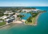 aerial view of a lakeside university campus with lagoon and curved shoreline