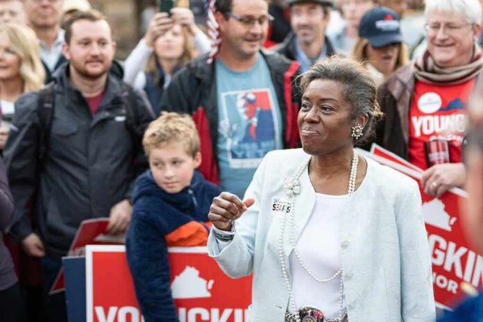 Woman addressing a crowd at an outdoor event