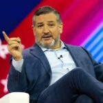 Ted Cruz speaking on stage, gesturing with one finger raised