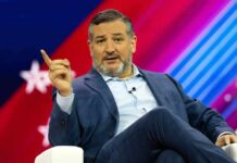 Ted Cruz speaking on stage, gesturing with one finger raised