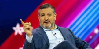 Ted Cruz speaking on stage, gesturing with one finger raised