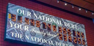 national debt clock sign with digital numbers