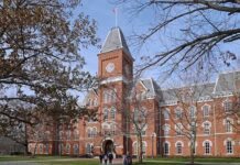 Viral Campus Video Leads to Student’s Withdrawal Historic university building with students walking in front during autumn
