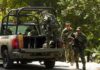 Congo Ambush Leaves Around 20 Casualties soldiers in camouflage near a military pickup truck
