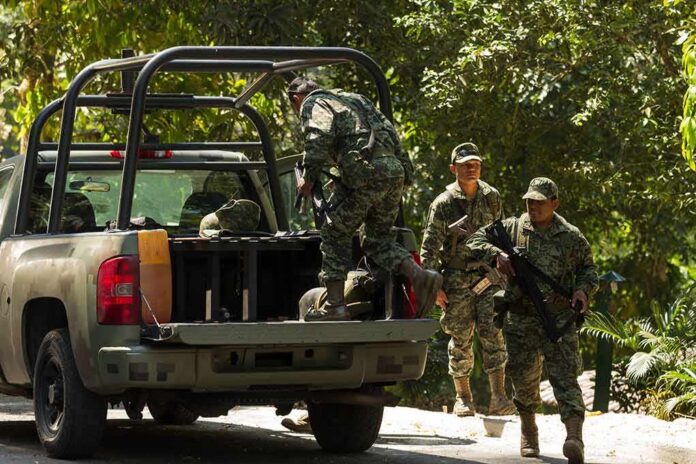 soldiers in camouflage near a military pickup truck