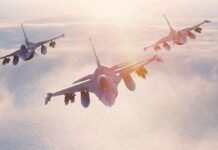 NATO Warns Attackers: “Block, Blunt, Break” Three fighter jets flying in formation above clouds at sunrise