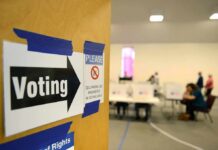 Election Fraud Claims Spark Investigation Voting sign on door leading to polling place