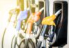 A New Fuel Break for Drivers and Businesses Fuel pump nozzles at a gas station