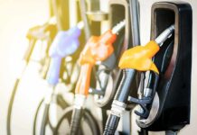 A New Fuel Break for Drivers and Businesses Fuel pump nozzles at a gas station