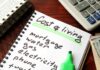 Low Unemployment Masks a Cooling Job Market Budget notebook with cost of living list, calculator, and cash